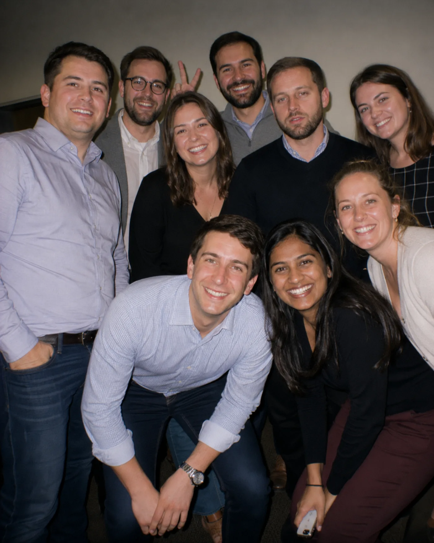 Colleagues cheering together at an evening company event